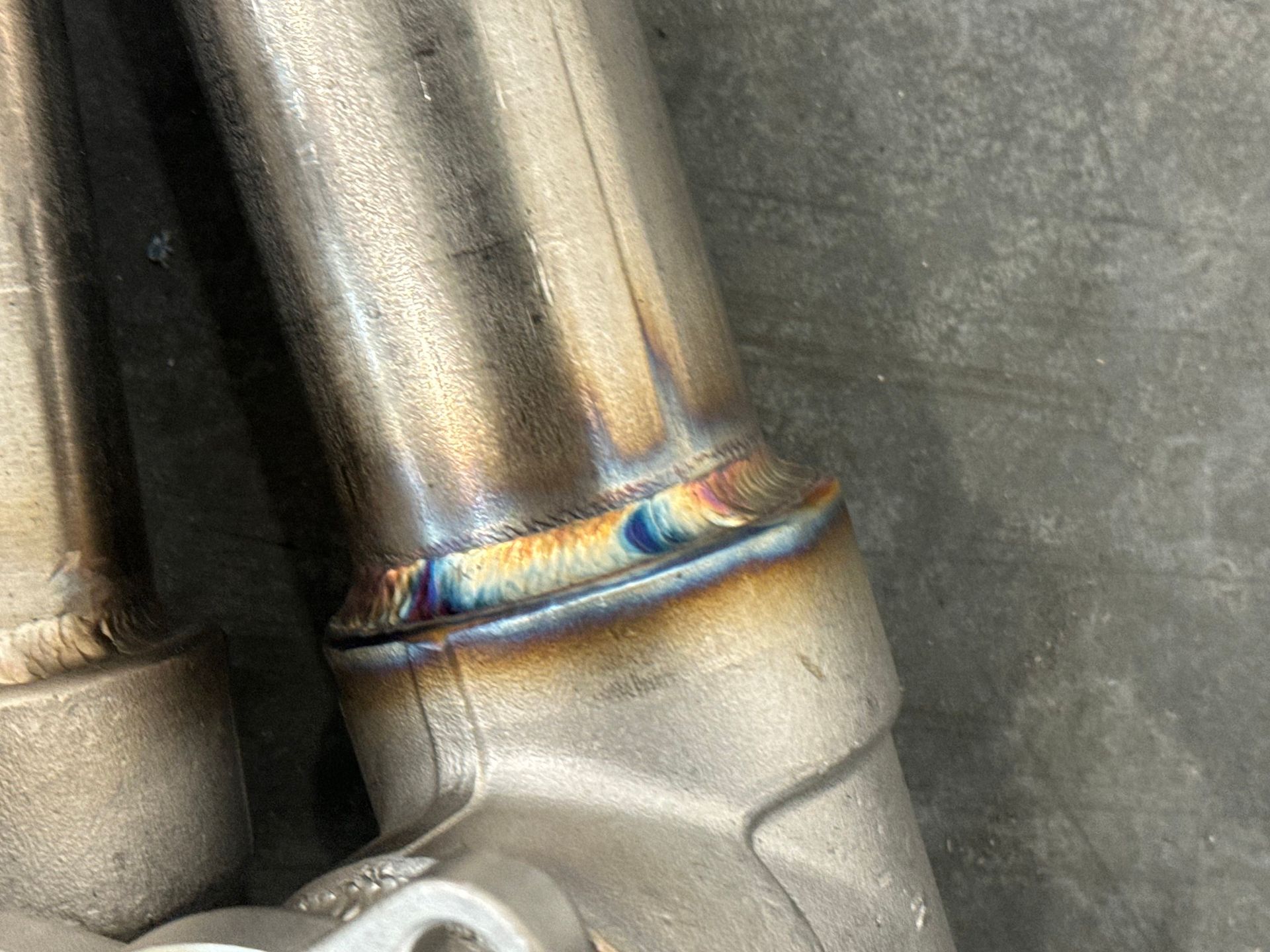 A close up of a welding job on a metal pipe.