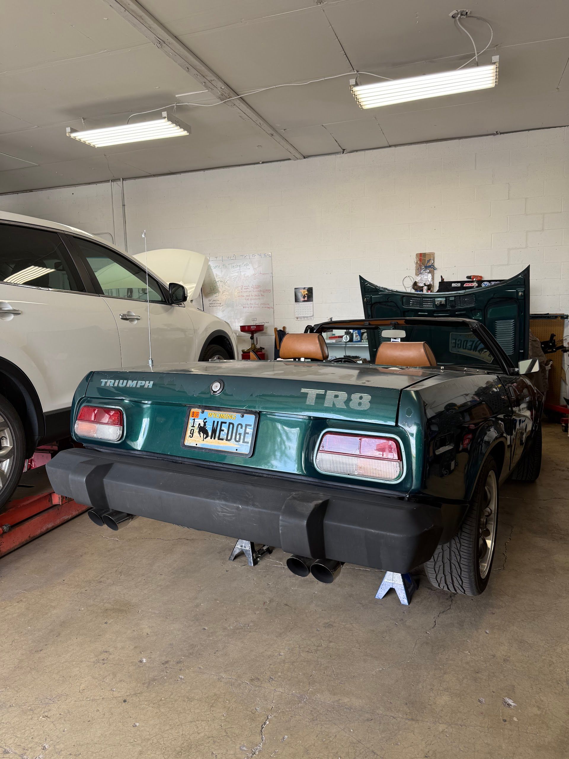 Classic Green Sports Car Inside Auto Repair Shop | Knight Motor Company