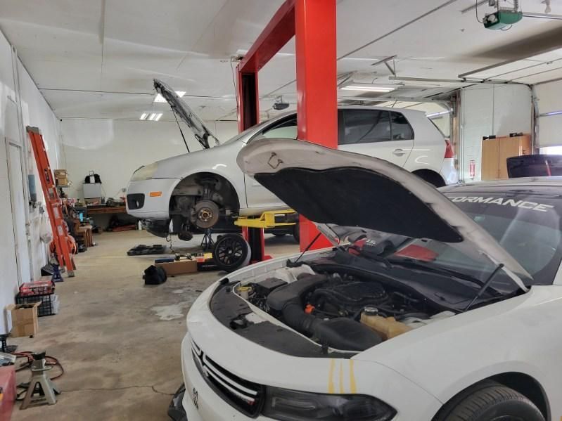 Cars Being Serviced Inside Auto Repair Garage | Knight Motor Company