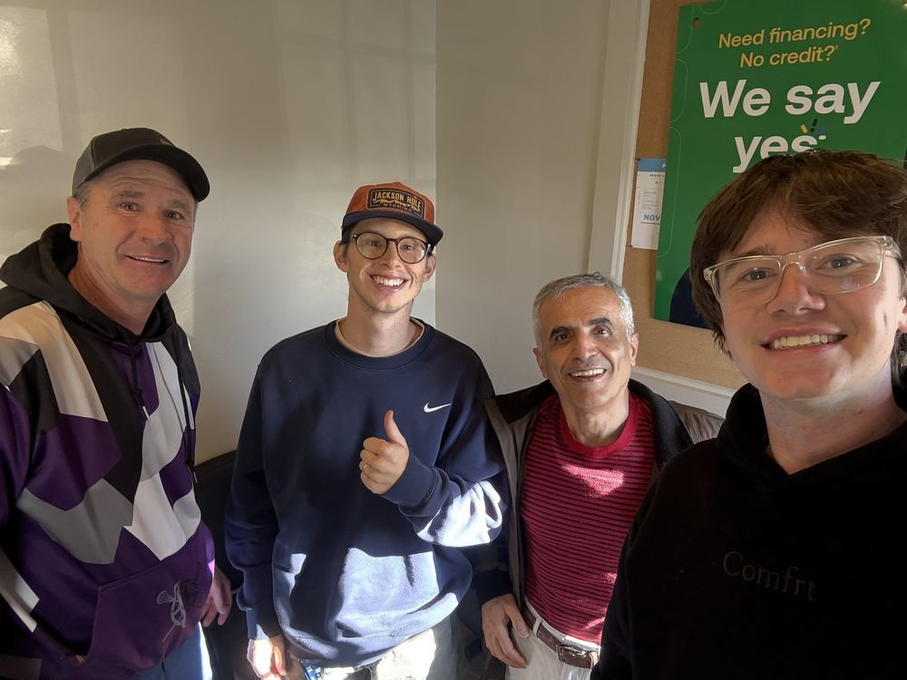 Four People Smiling Inside Auto Repair Shop | Knight Motor Company
