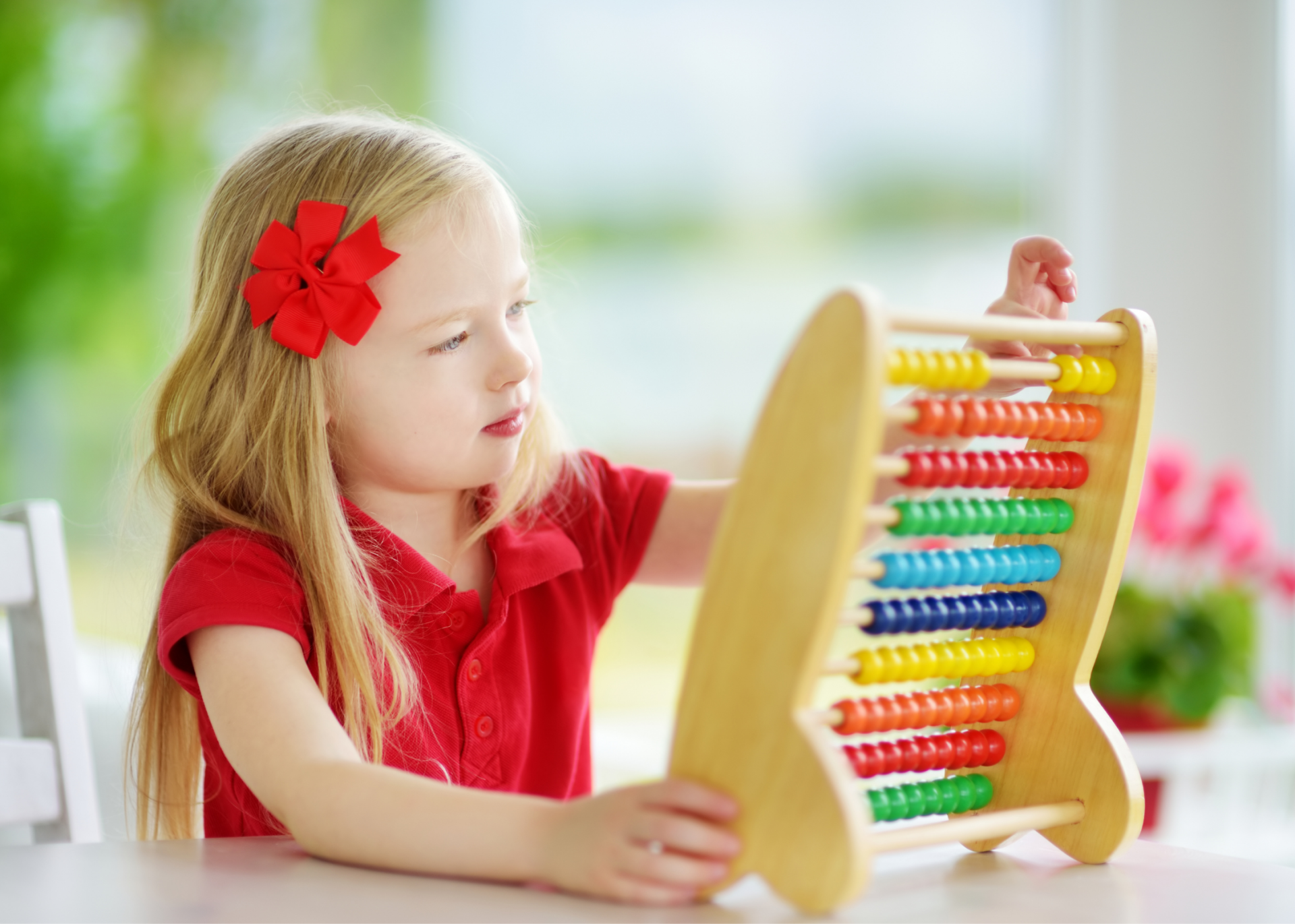 Preschool age child playing with Abacus