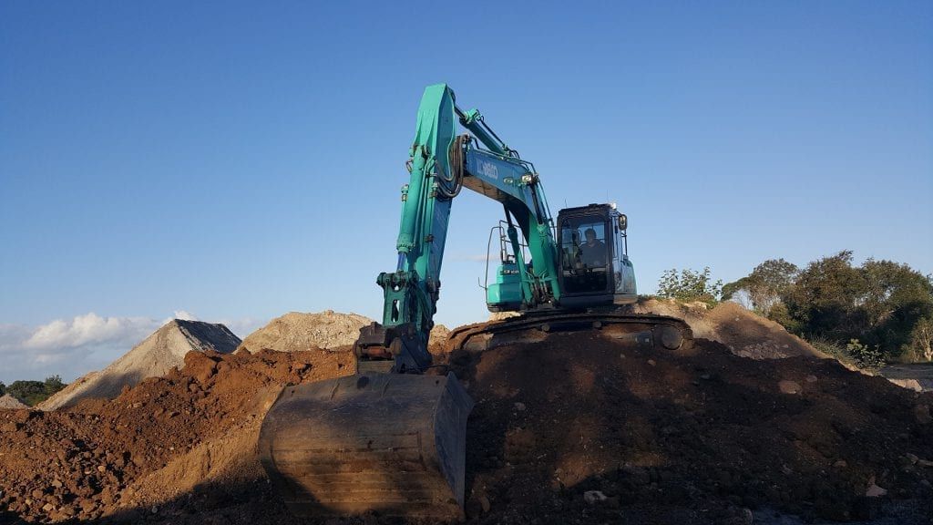 Excavator Digging a Trench in Brown Soil, Outdoors — Snell Earthworx In Craignish, QLD