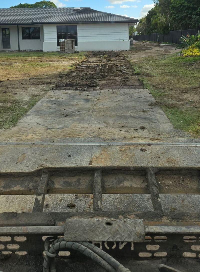 White Bobcat skid-steer loader parked outdoors with a yellow construction vehicle in the background — Snell Earthworx In Craignish, QLD