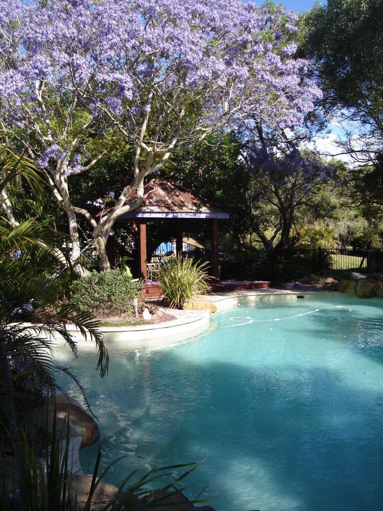 Swimming Pool with a Gazebo, Surrounded by Lush Trees — Snell Earthworx In Maryborough, QLD