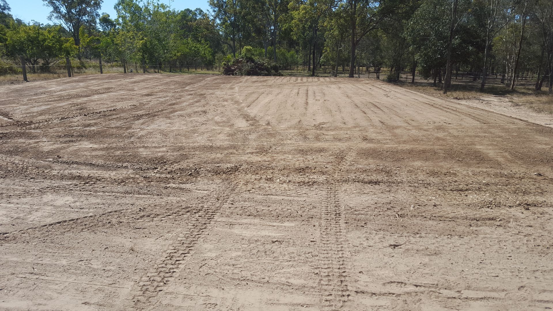 Ploughed Field, Dirt Brown, with Tire Tracks and Treeline — Snell Earthworx In Maryborough, QLD