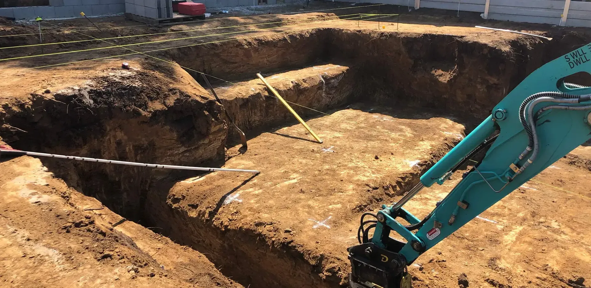 An Excavator Digs a Foundation in Dirt — Snell Earthworx In Craignish, QLD
