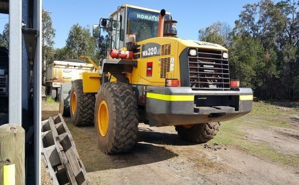 Yellow Komatsu Wheel Loader on a Dirt Road — Snell Earthworx In Craignish, QLD