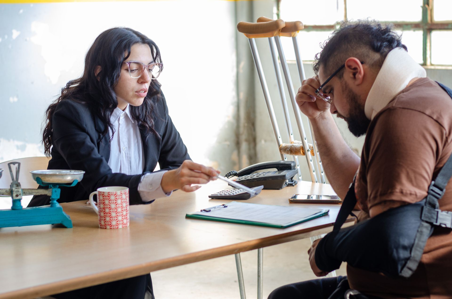 Auto injury lawyer helps injured man with accident paperwork.