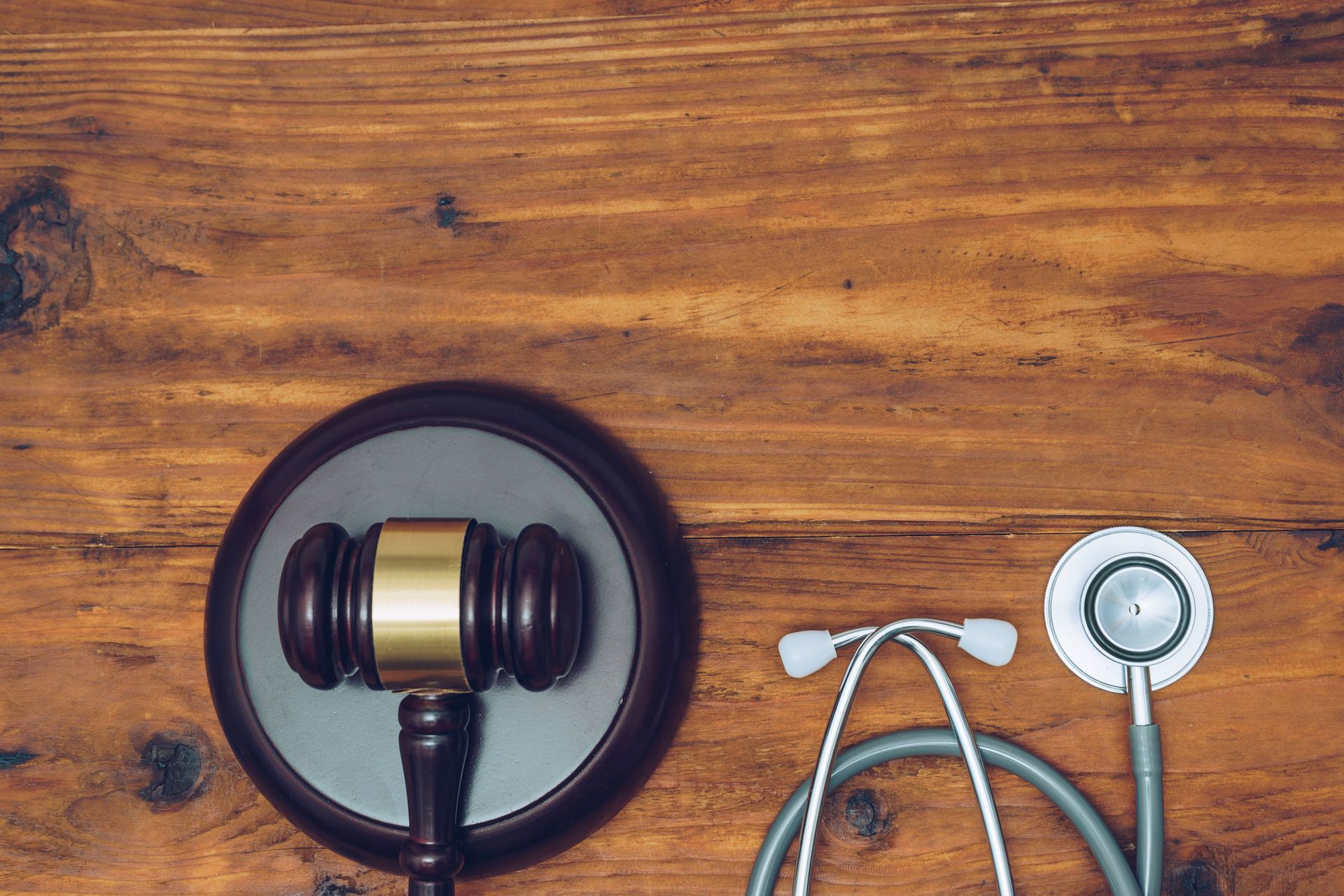 A gavel and stethoscope on a table representing a Personal Injury Lawyer