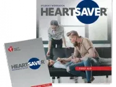 Two Heartsaver first aid guides: student workbook and reference guide. The guides show people giving aid to a person on a couch.