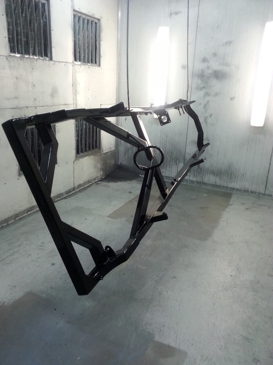 In A Room, A Metal Frame Is Hanging From The Ceiling — Border Security Doors & Powder Coating in Wodonga, VIC