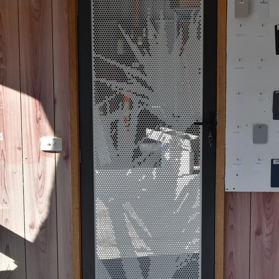 A Glass Door With A Picture Of A Palm Tree On It — Border Security Doors & Powder Coating in Wodonga, VIC