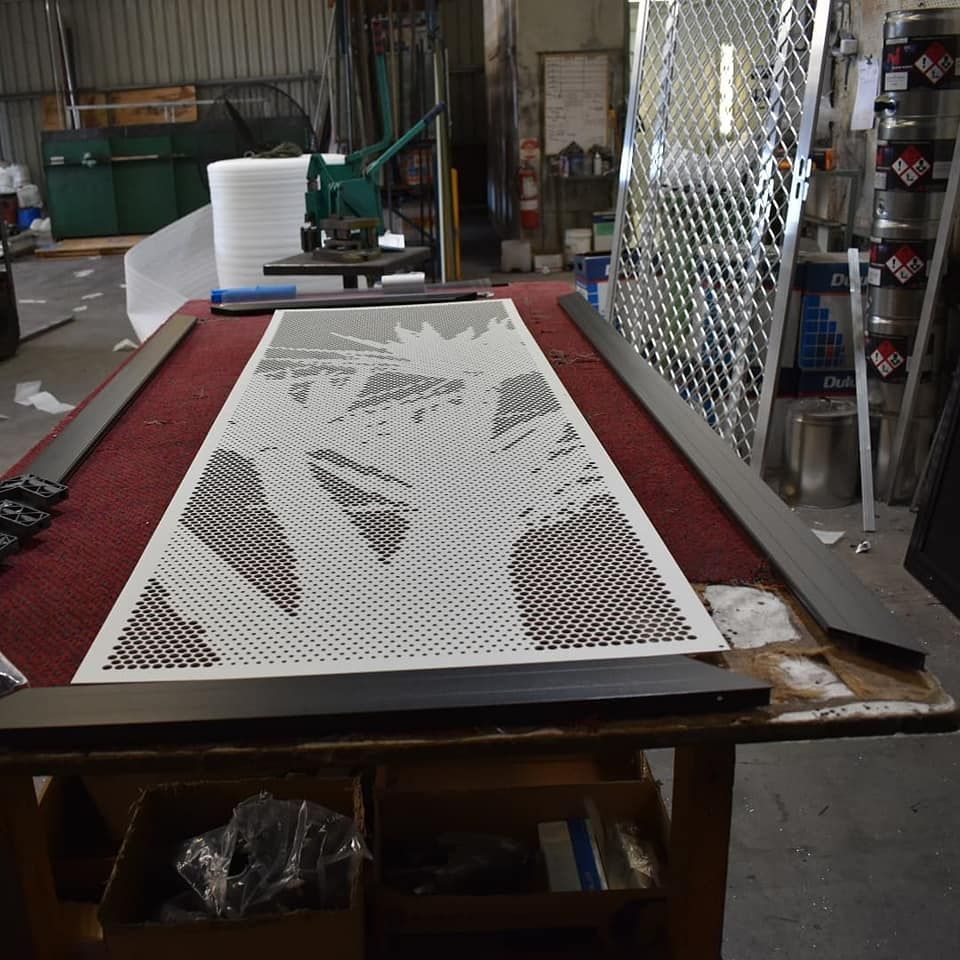 A Large Piece Of Metal Is Placed On A Table — Border Security Doors & Powder Coating in Albury, NSW