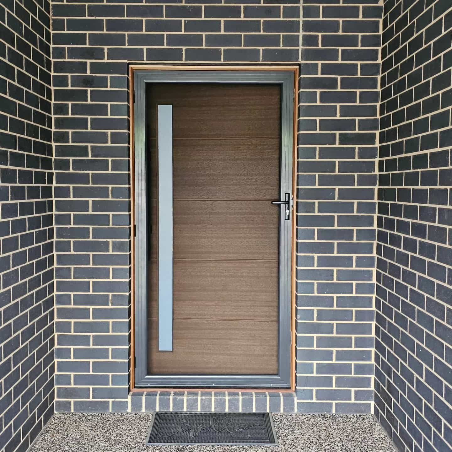 A Brick Wall With A Door In It — Border Security Doors & Powder Coating in Wodonga, VIC