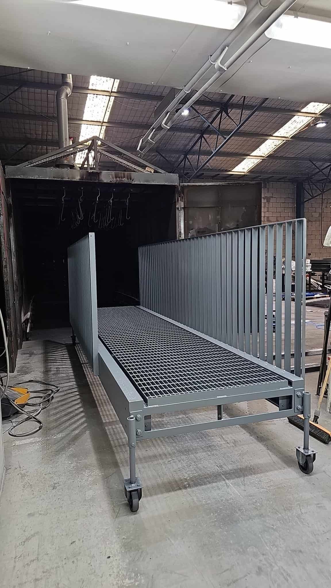 A Metal Bed With Wheels Is Sitting — Border Security Doors & Powder Coating in Wodonga, VIC