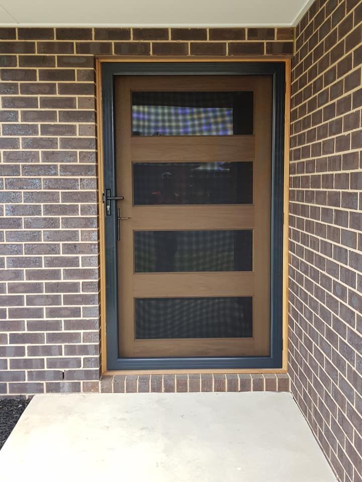 a brick wall with a screen door on it
