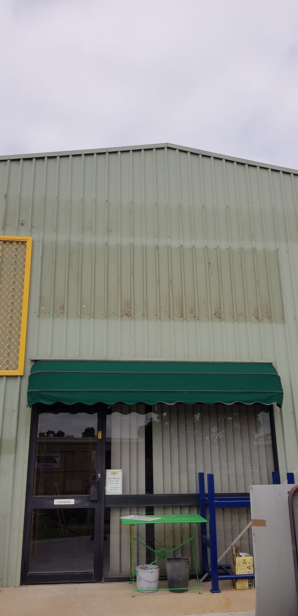 A Green Awning Is On The Front Of A Building — Border Security Doors & Powder Coating in Wodonga, VIC