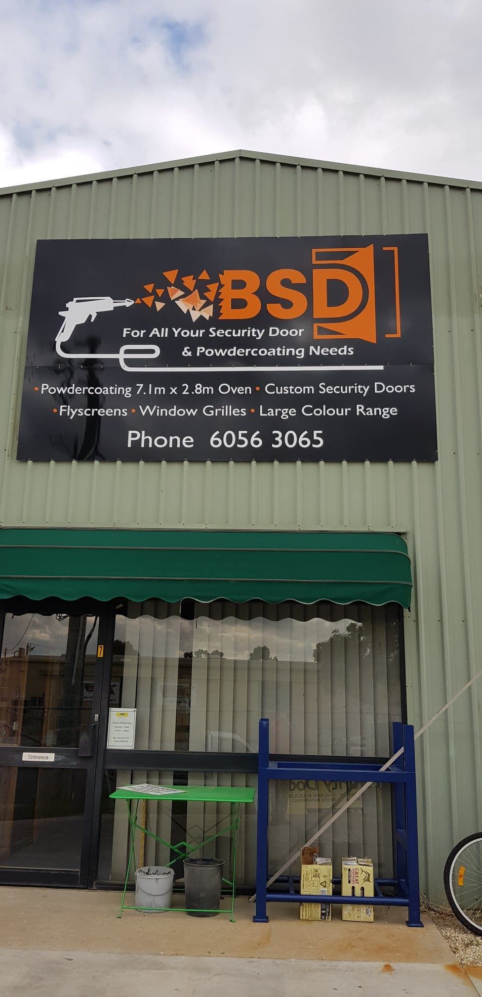 The Front Of A Building With A Sign That Says Bsd On It — Border Security Doors & Powder Coating in Wodonga, VIC