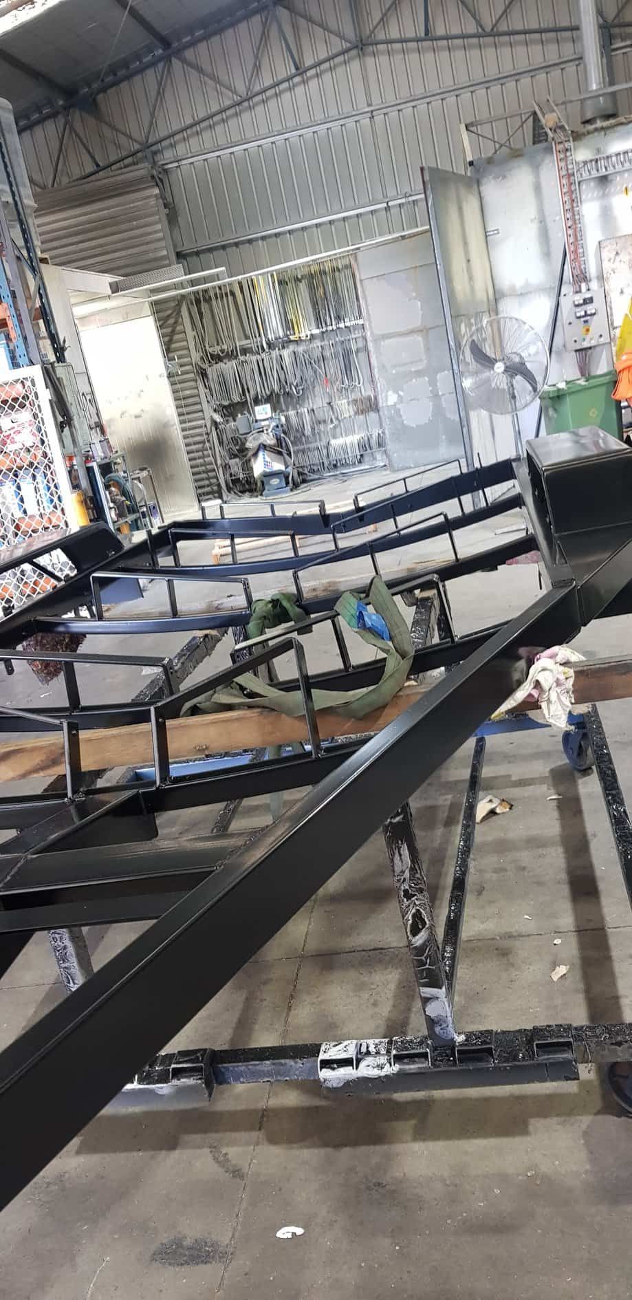 A Metal Structure Is Being Built In A Warehouse — Border Security Doors & Powder Coating in Wodonga, VIC