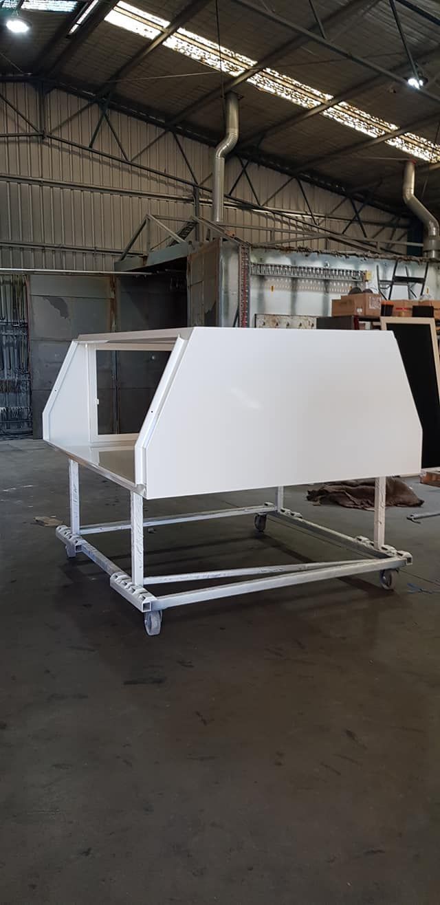 A White Metal Color Is Sitting On A Cart — Border Security Doors & Powder Coating in Wodonga, VIC