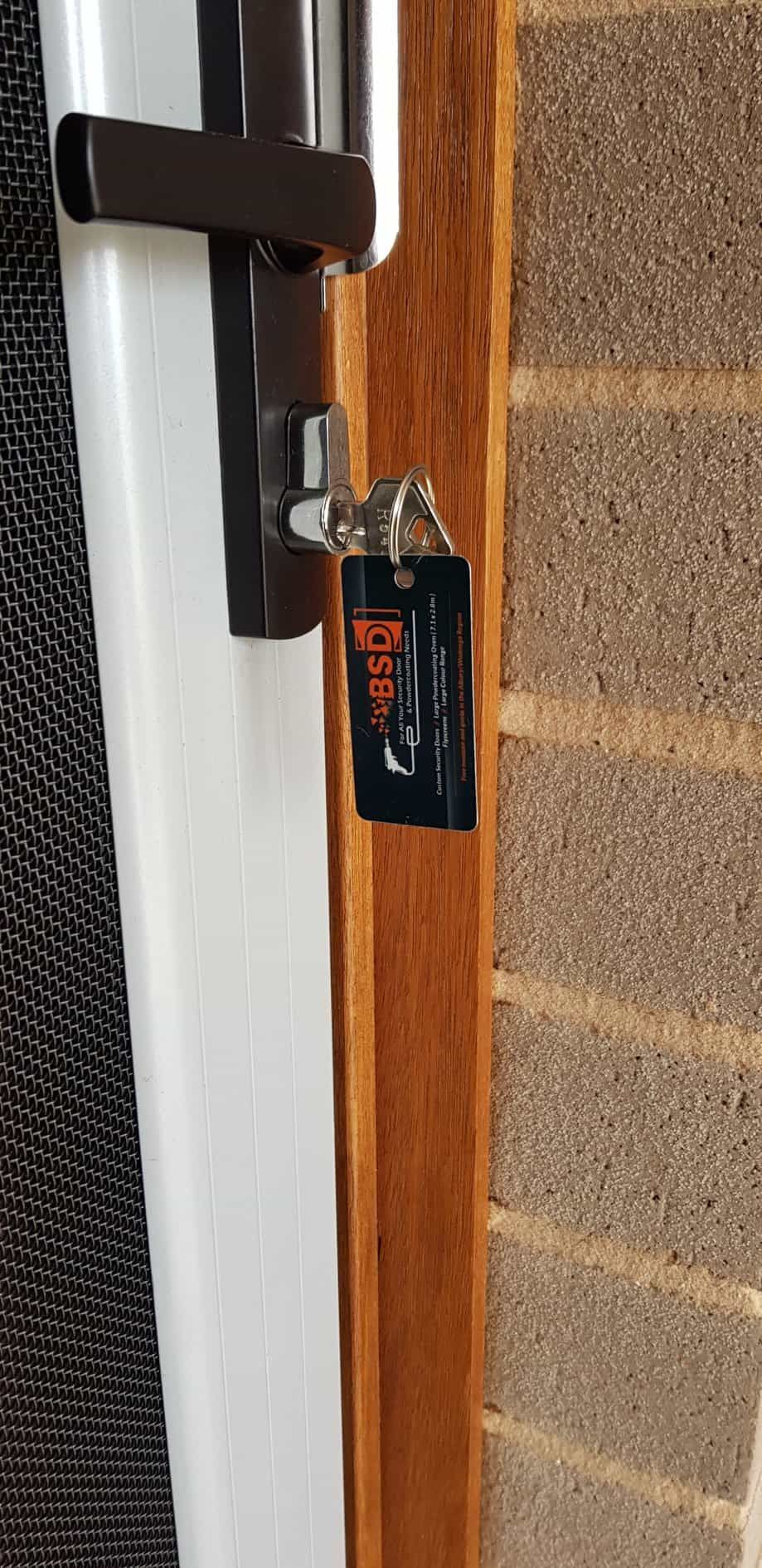 A Close Up Of A Door With A Key On It — Border Security Doors & Powder Coating in Wodonga, VIC