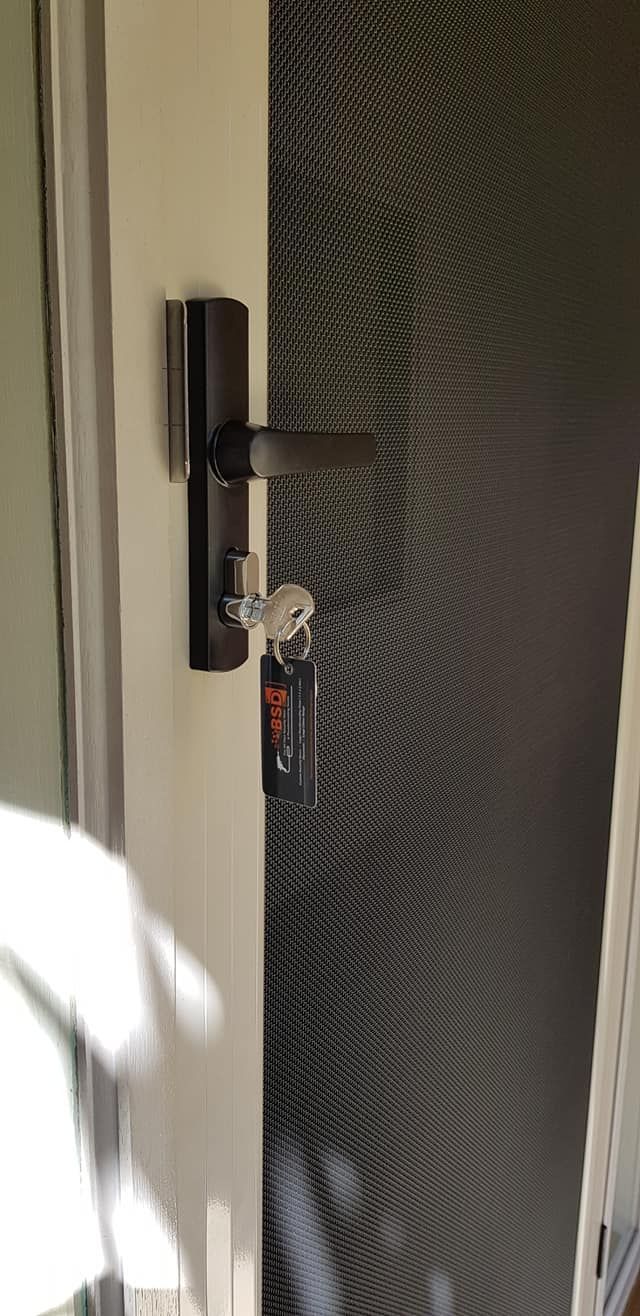 A Close Up Of A Door With A Key On It — Border Security Doors & Powder Coating in Wodonga, VIC