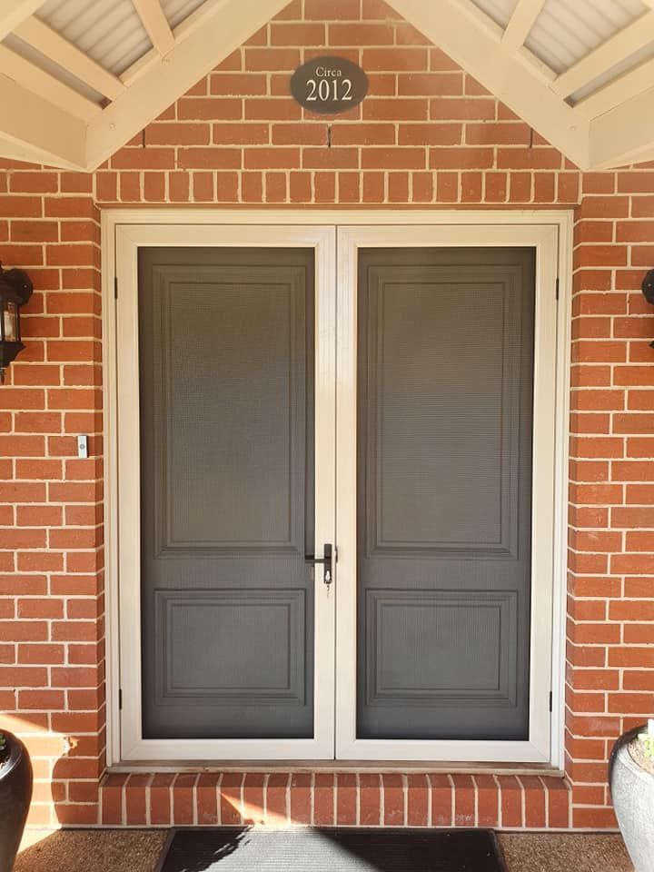 A Brick Building With Window — Border Security Doors & Powder Coating in Wodonga, VIC