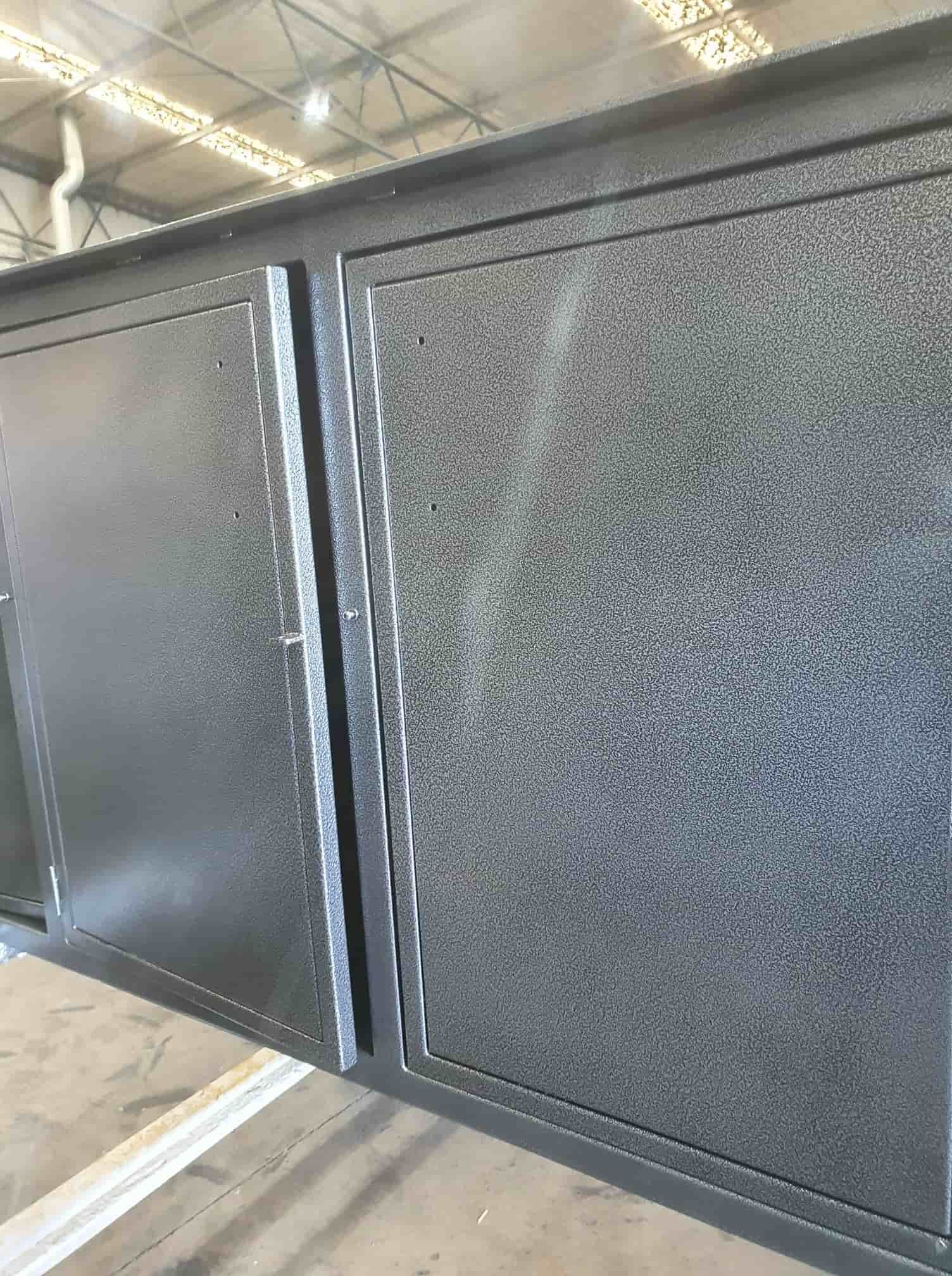 A Black Metal Cabinet Is Sitting On Top Of A Wooden Floor — Border Security Doors & Powder Coating in Wodonga, VIC