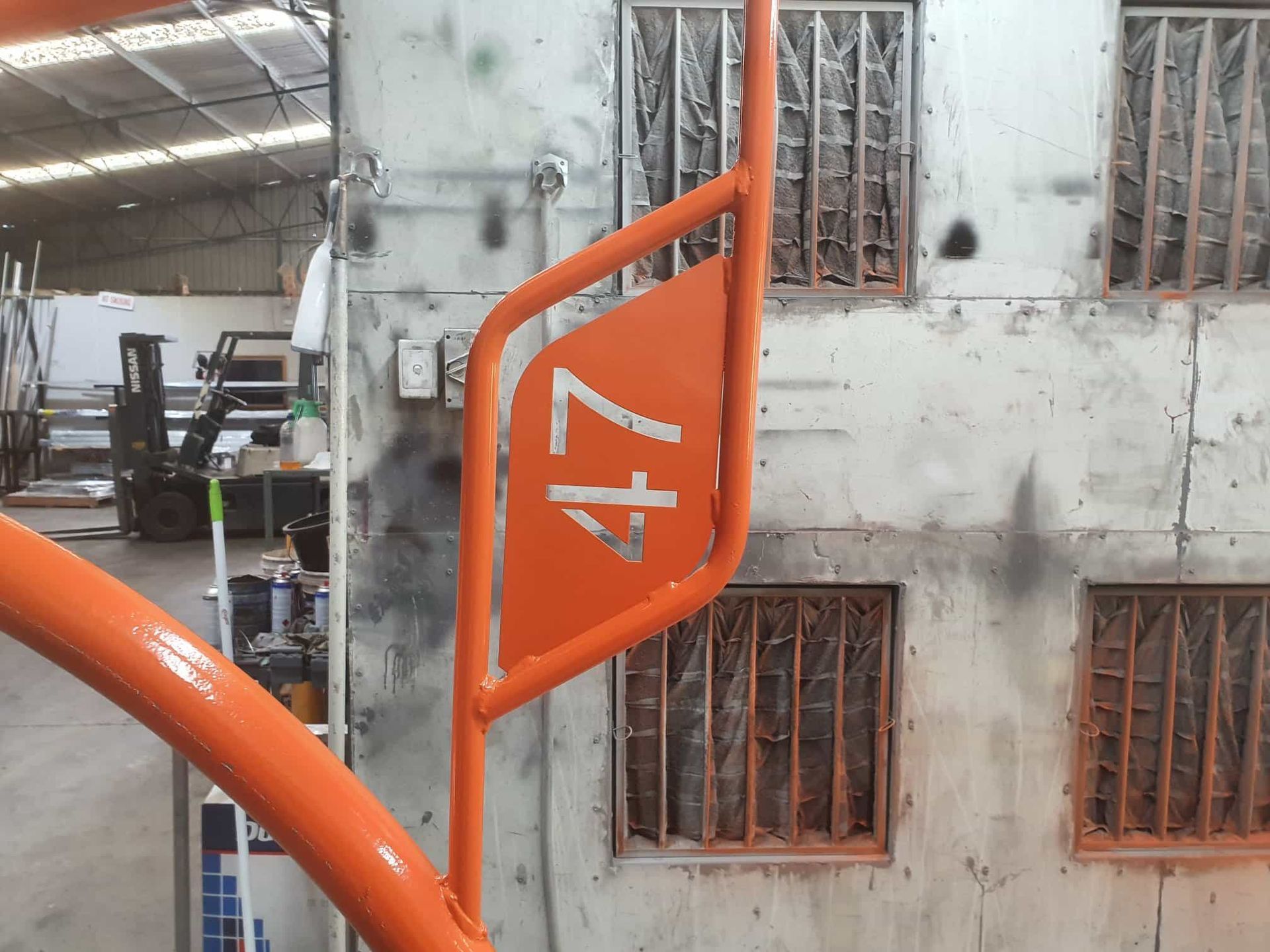 An Orange Sign With The Number 17 On It — Border Security Doors & Powder Coating in Wodonga, VIC