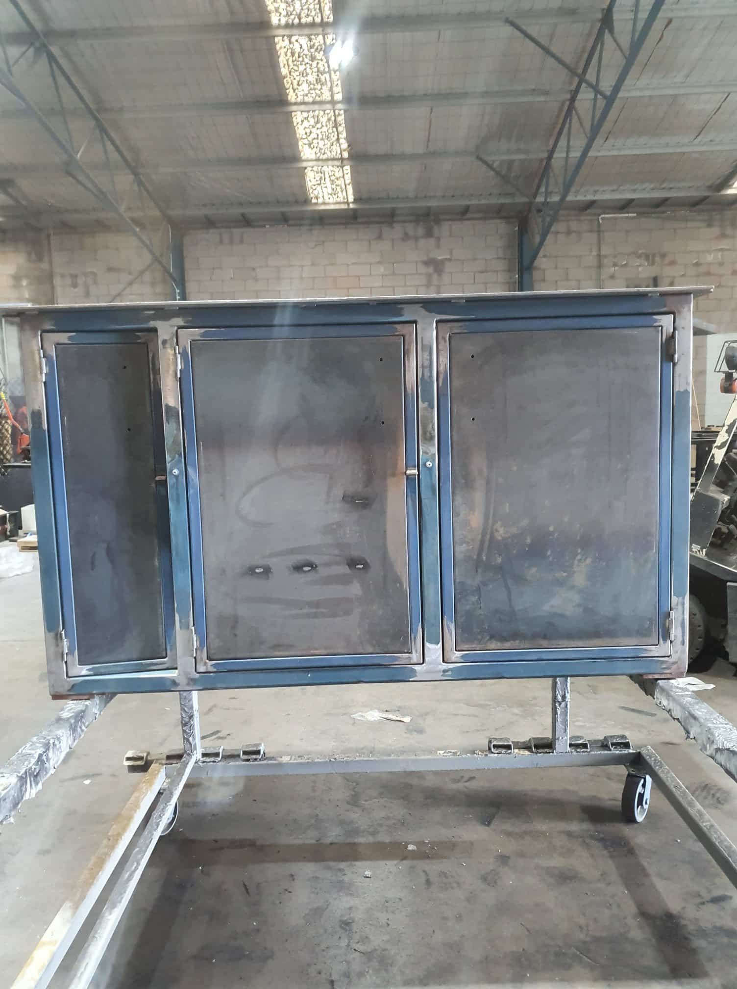 A Metal Box Is Sitting On A Cart In A Warehouse — Border Security Doors & Powder Coating in Wodonga, VIC
