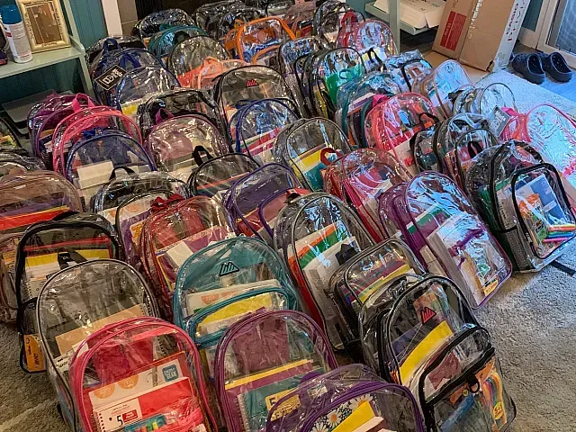 Backpacks with school supplies, organized by the SMG Team
