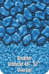 A picture of a swimming pool with a blue stone wall and water.