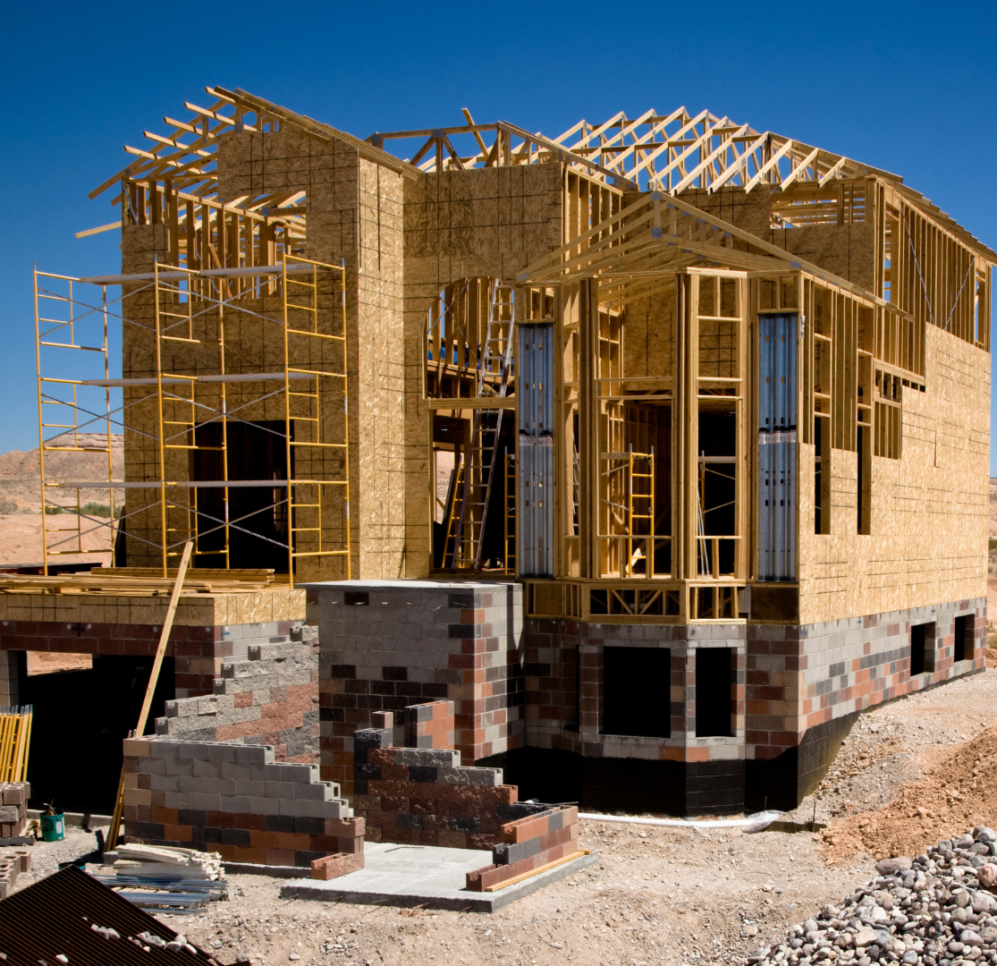 A house that is being built with a blue sky in the background