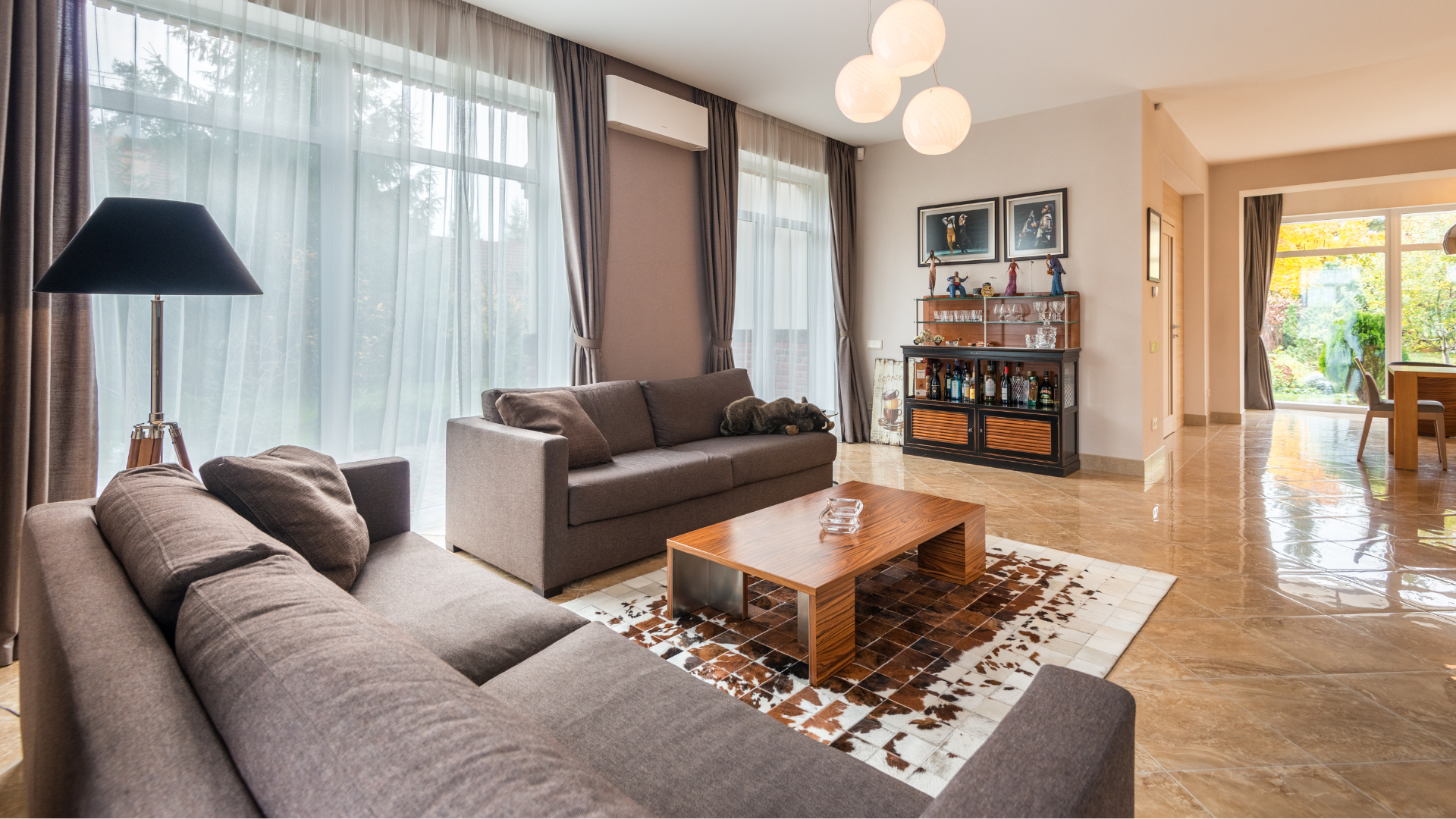 A living room with a couch , coffee table and rug.