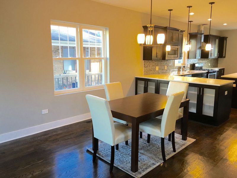 A kitchen with a table and chairs in it