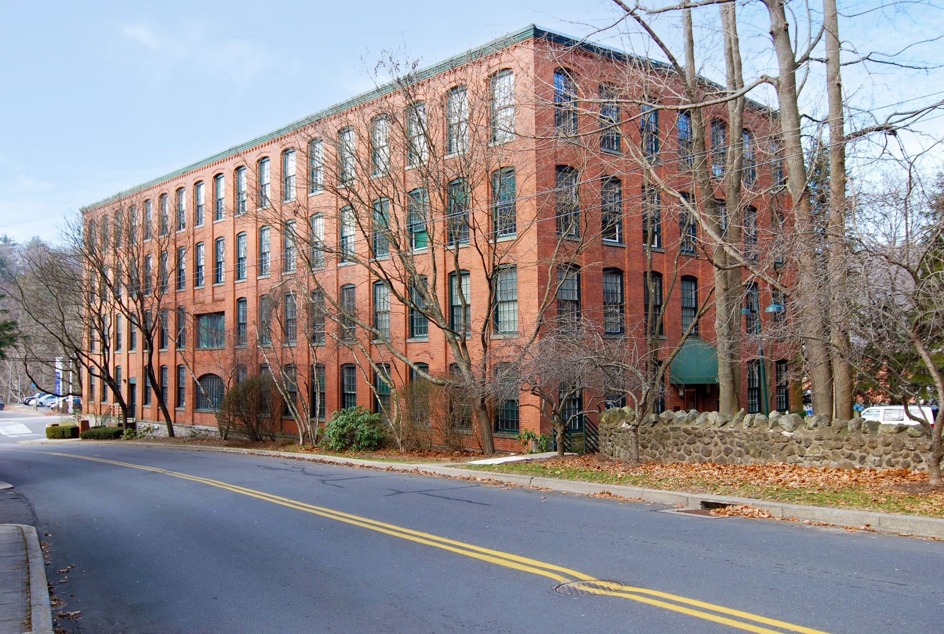 A large brick building with a green awning on the side of it