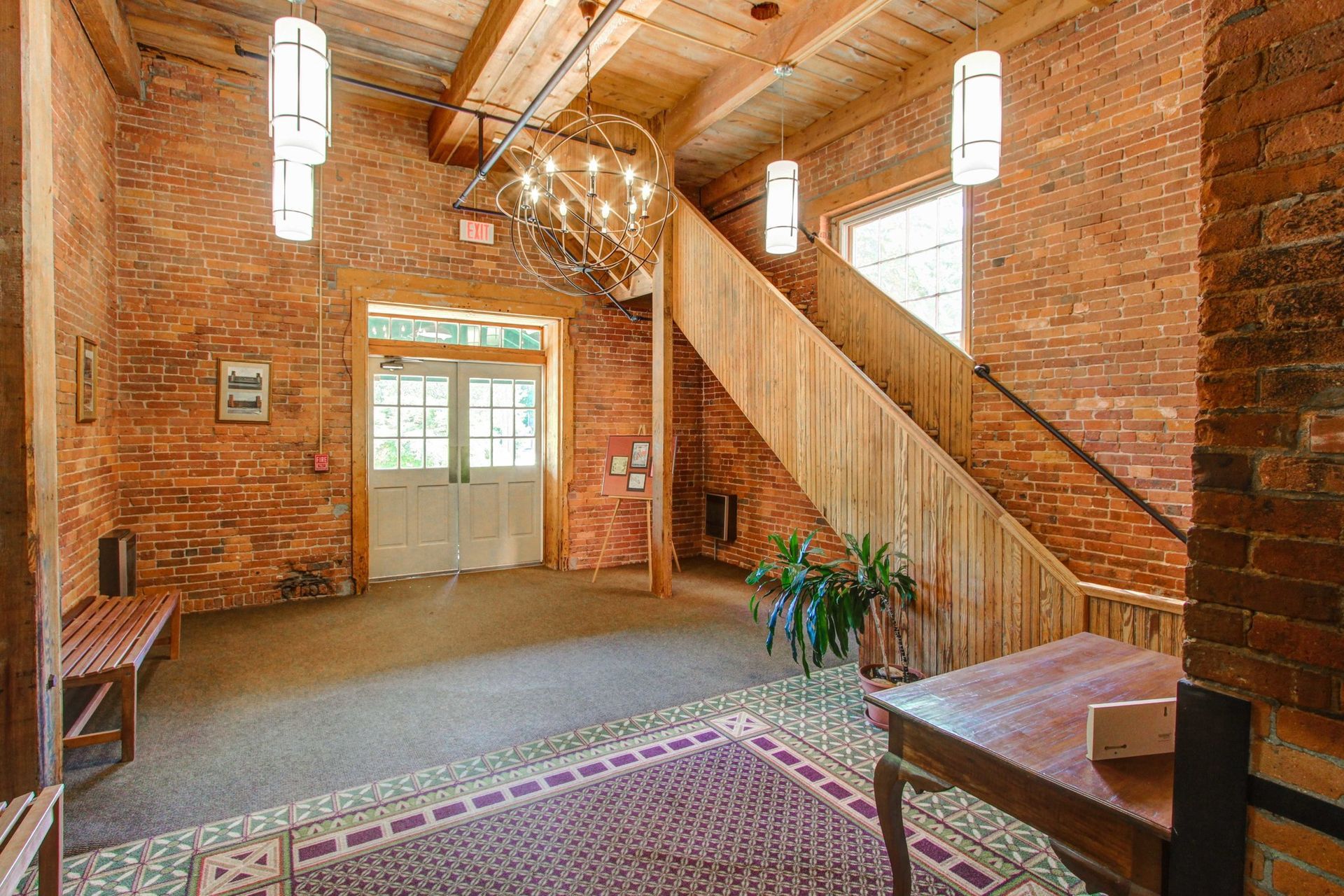 There is a wooden staircase in the middle of the room.
