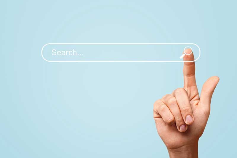 A hand is pointing at a search bar on a blue background.
