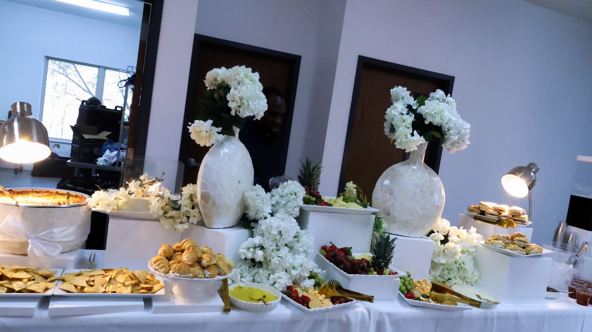 A table with a lot of food and flowers on it
