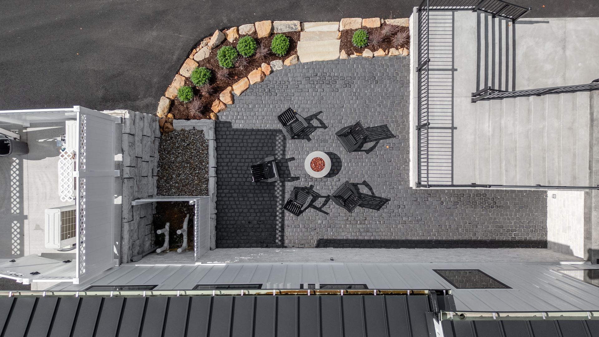Overhead view of a patio with seating around a fire pit, next to a rock garden and staircase. Morgantown, Sunnyside, Woodburn