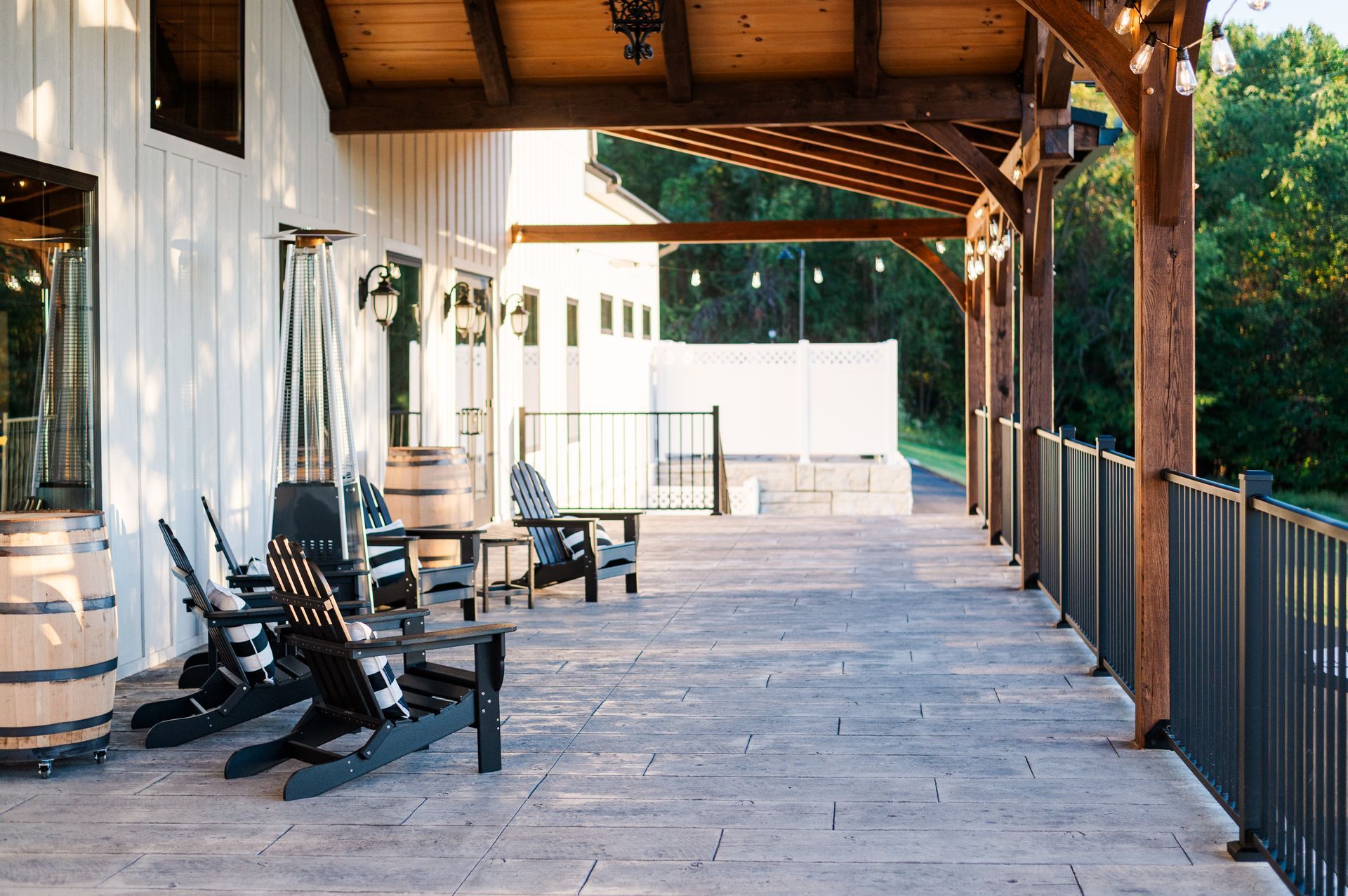 Outdoor patio with seating, wooden beams, and a railing overlooking greenery. Morgantown