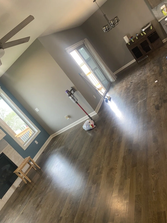 A vacuum cleaner is sitting on the floor in a living room.