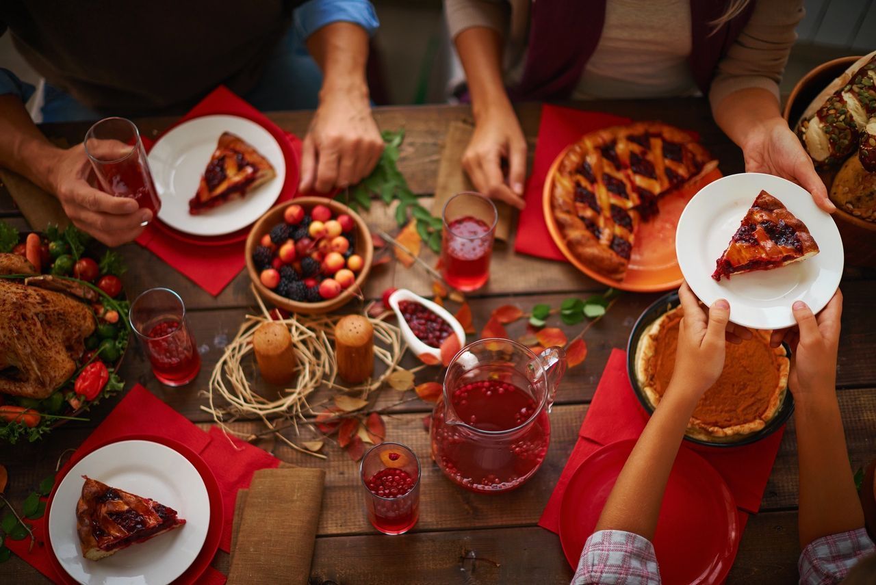 A Group Of People Sitting At A Table With Plates Of Food - Northfield, IL - Be40Strong