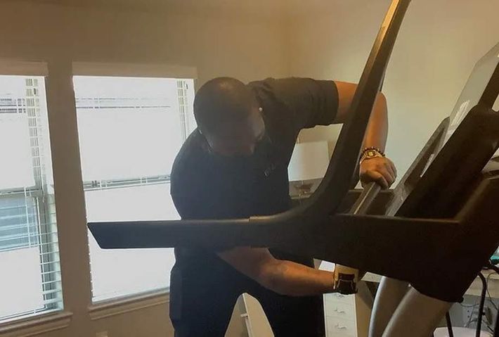 a man wearing a watch is working on a treadmill