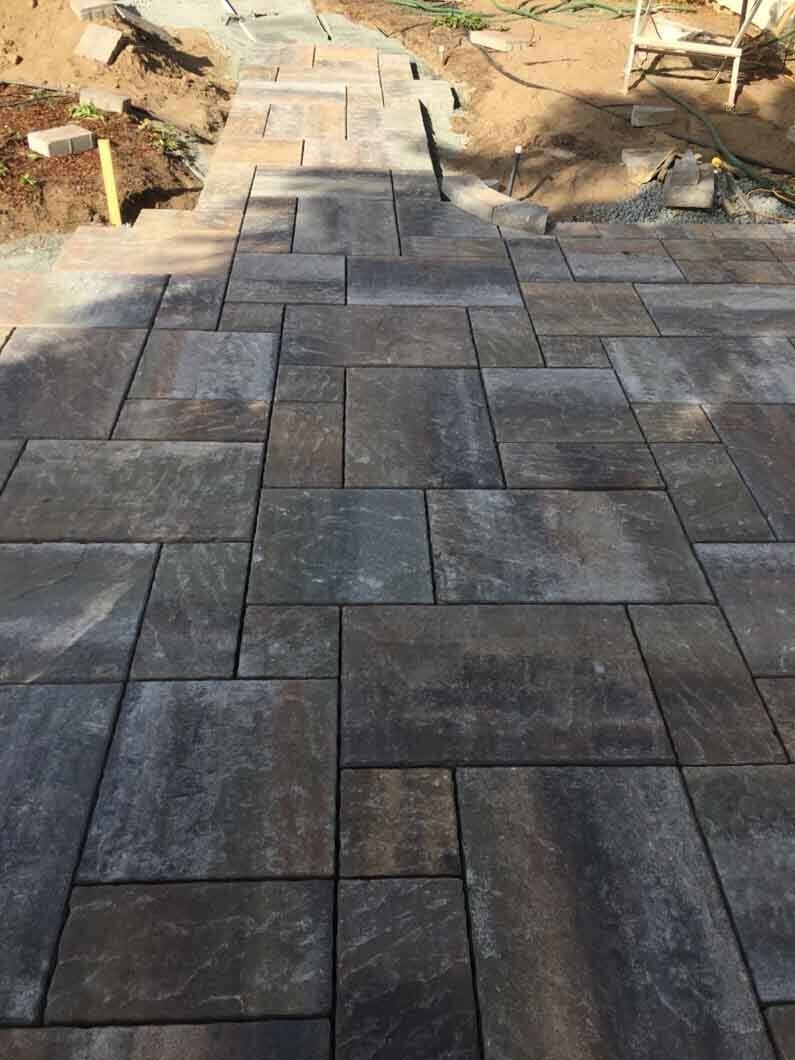 A patio with a staircase leading up to it is being built.