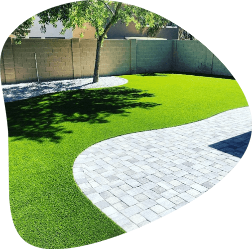 artificial turf with lush green landscape and concrete pavers