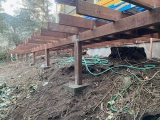 A wooden deck is being built on top of a dirt hill.