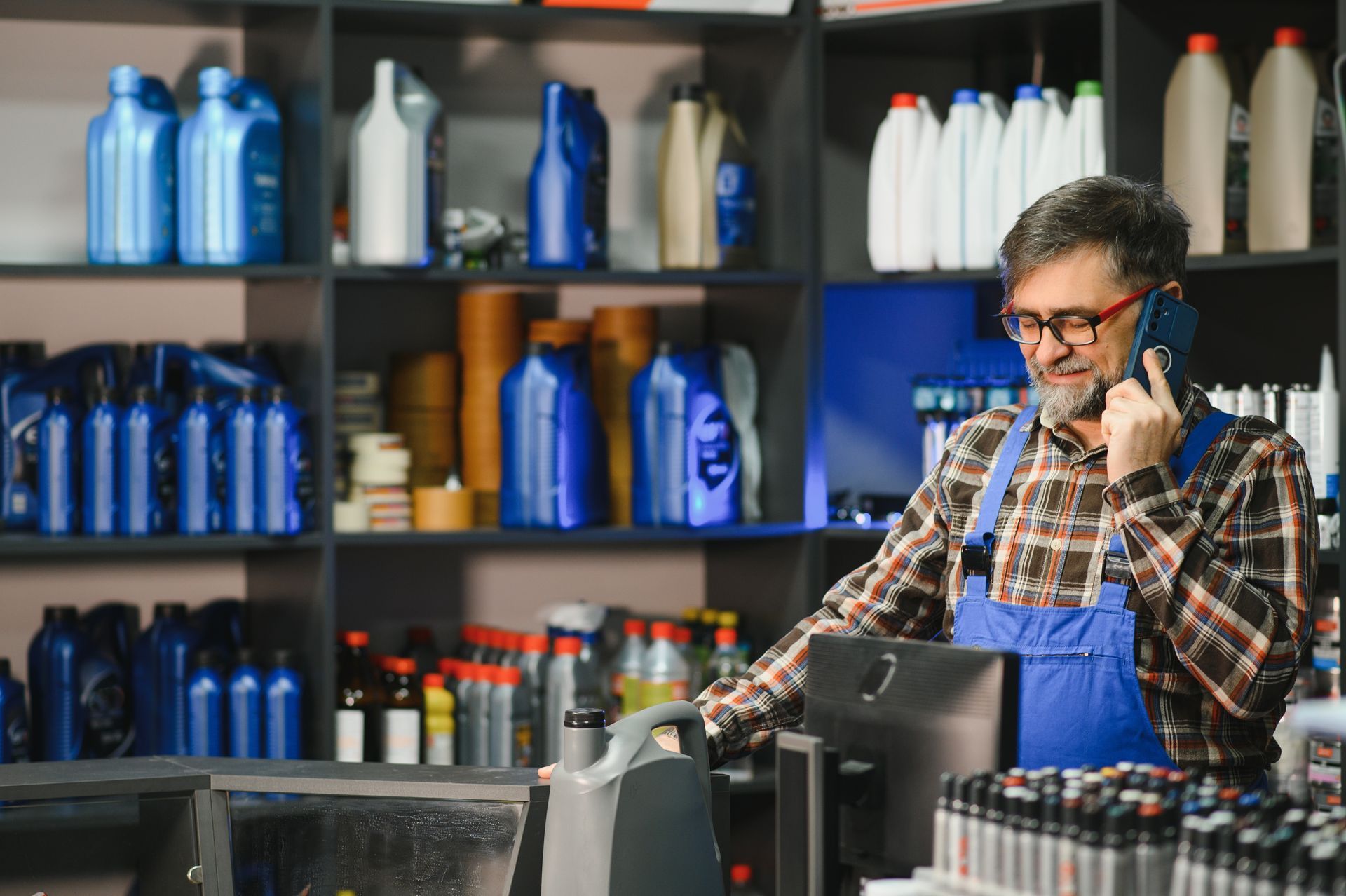 A shop owner or manager reviewing something on a tablet or laptop