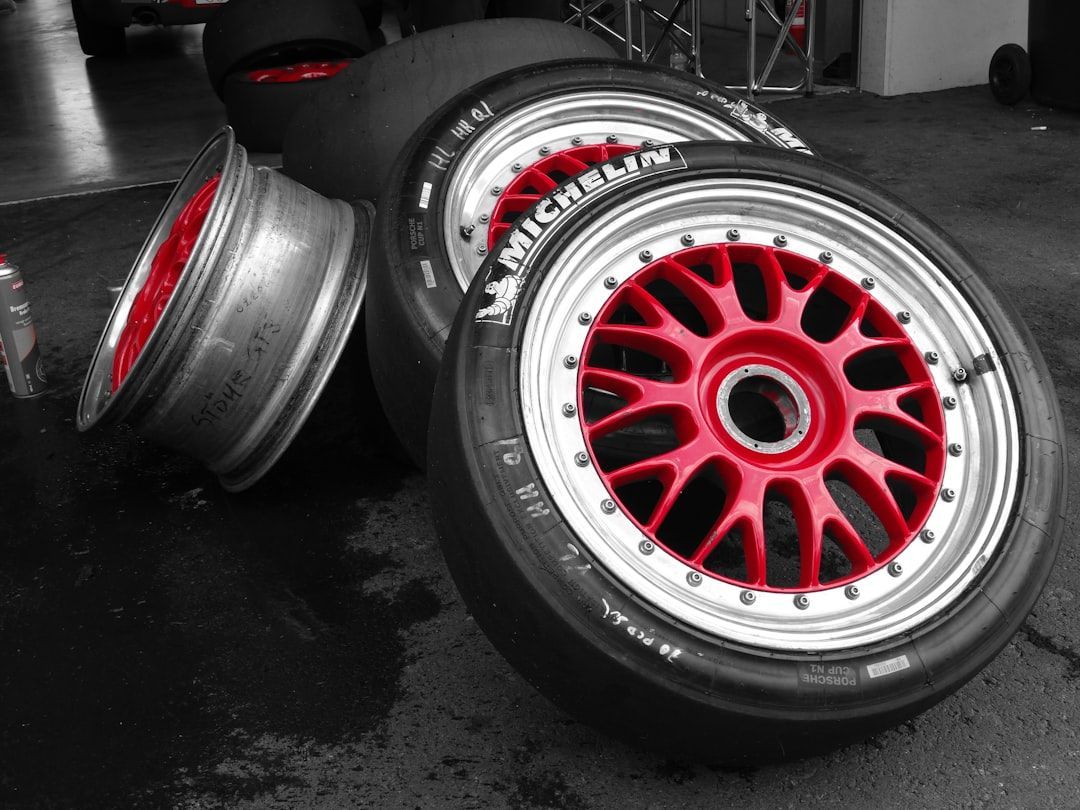 Red and black racing tires arranged in a garage, ideal for auto repair promotion ideas