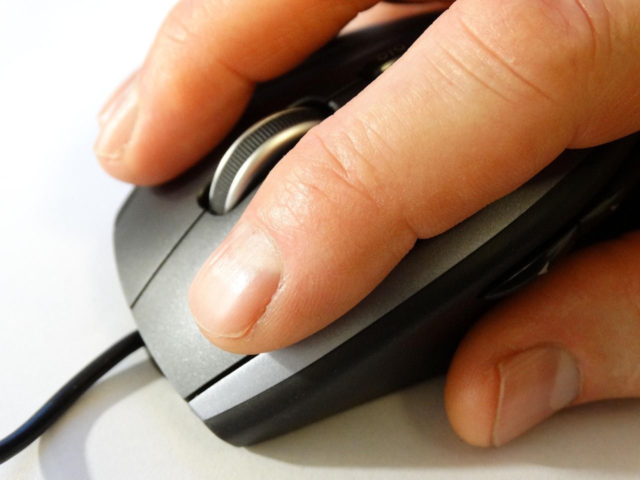 Hand clicking a computer mouse representing improving CTR strategies